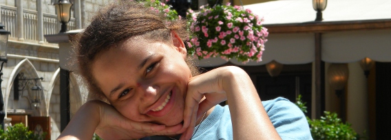 Smiling girl resting her chin on her hands